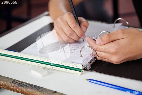 Image of Schoolboy Copying At Desk During Examination