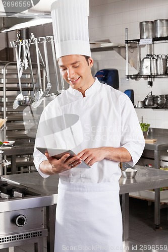 Image of Male Chef Using Digital