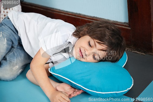 Image of Boy Lying On Heartshaped Pillow In Kindergarten