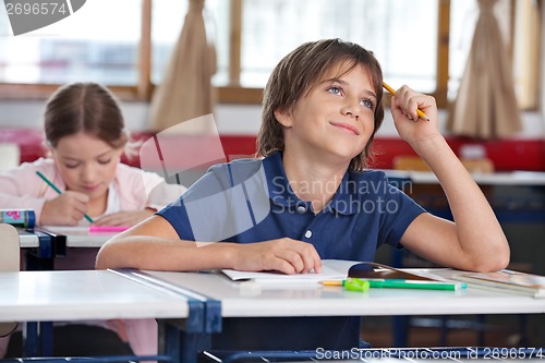 Image of Little Boy Smiling While Looking Up In Classroom