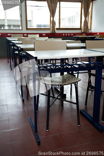 Image of Desk And Chairs In A Row At Classroom