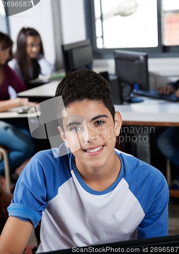 Image of Happy Teenage Schoolgirl Sitting In Computer Lab
