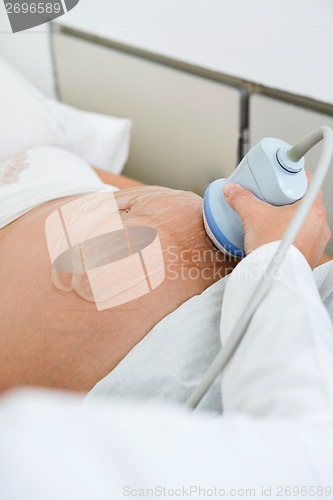 Image of Doctor Scanning Pregnant Woman's Belly