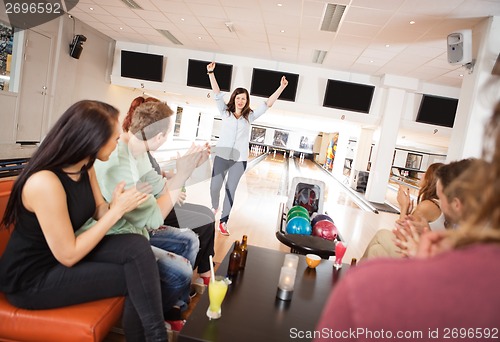 Image of Excited Woman With Friends Applauding