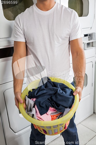 Image of Man With Clothes Basket In Laundry