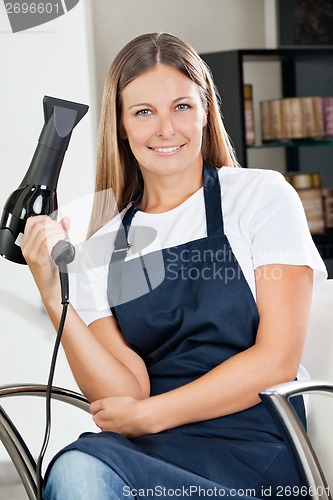 Image of Female Hairdresser Holding Hairdryer