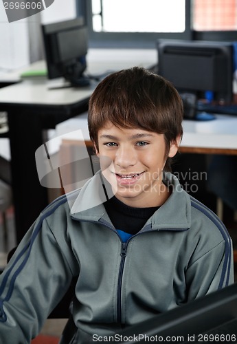 Image of Happy Schoolboy Sitting In Computer Class