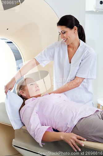 Image of Technician Preparing Patient For CT Scan