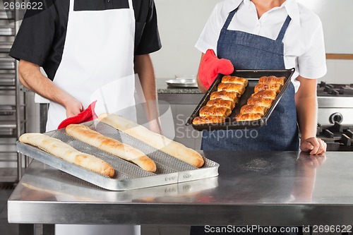 Image of Chefs Holding Trays Of Baked Bread