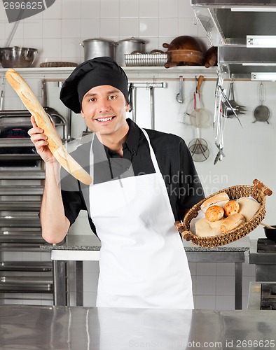 Image of Male Chef Holding Bread Loaf