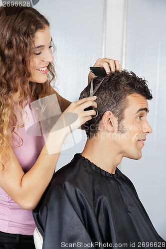 Image of Female Hairdresser Cutting Client's Hair