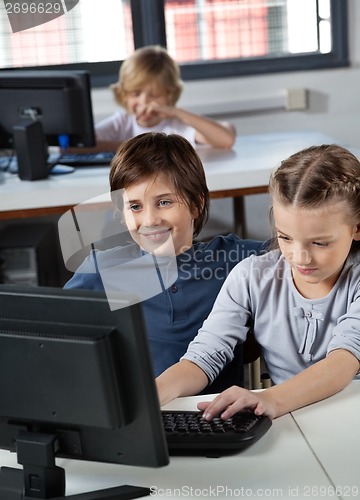 Image of Little Boy And Girl Using Desktop Pc