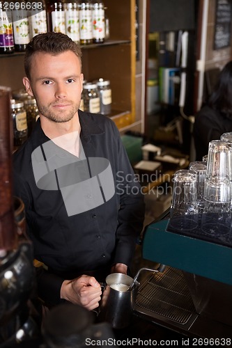 Image of Young Barista Working At Coffeeshop