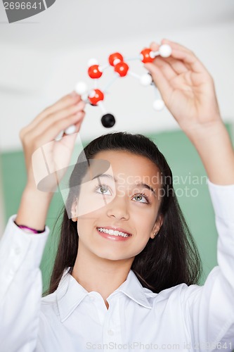 Image of Schoolgirl Looking At Molecular Structure In Classroom