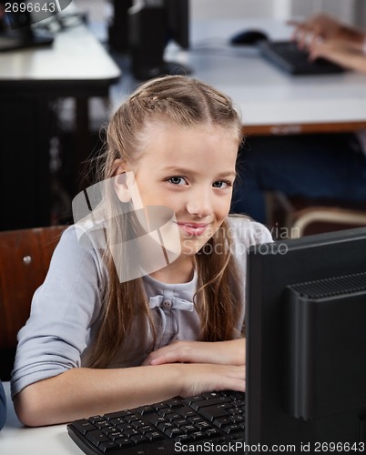 Image of Cute Schoolgirl With Computer At Desk