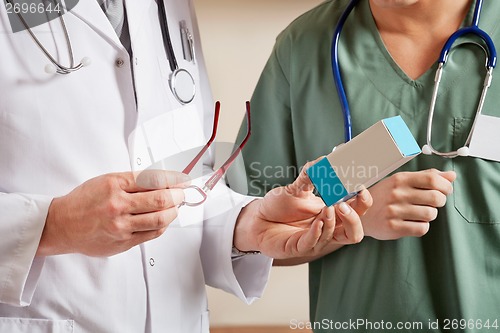 Image of Doctor Holding Medicine Box