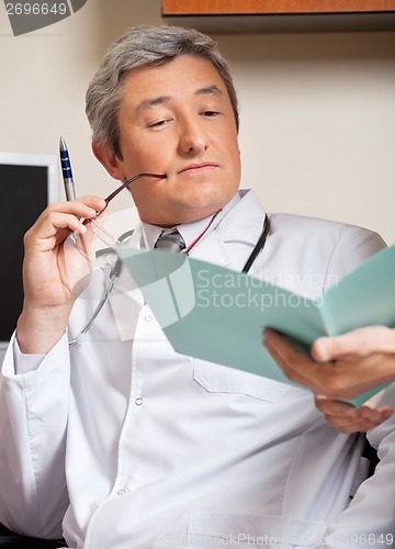 Image of Doctor Reading Medical Report