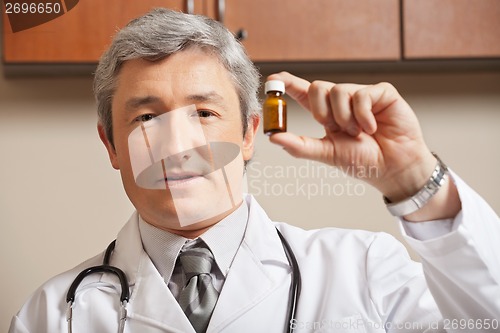 Image of Physician Holding Medicine Bottle