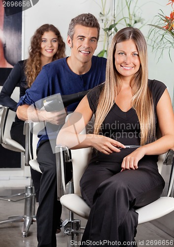 Image of Confident Team Of Hairdressers At Salon