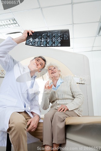 Image of Radiologist With Patient Looking At X-ray