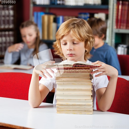 Image of Schoolboy With Stack Of Books