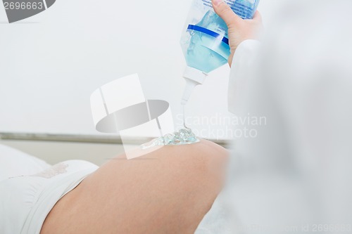 Image of Gynecologist Applying Gel On Pregnant Woman's Tummy