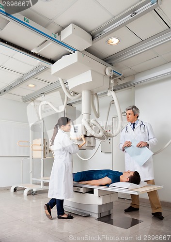 Image of Radiologists With Patient In X-ray Room