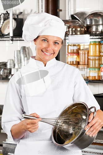 Image of Happy Chef Mixing Egg With Wire Whisk