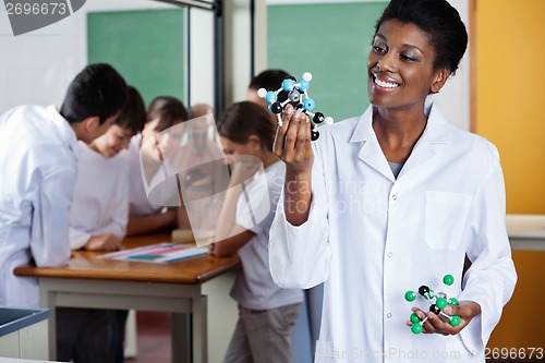 Image of Female Teacher Looking At Molecular Structure