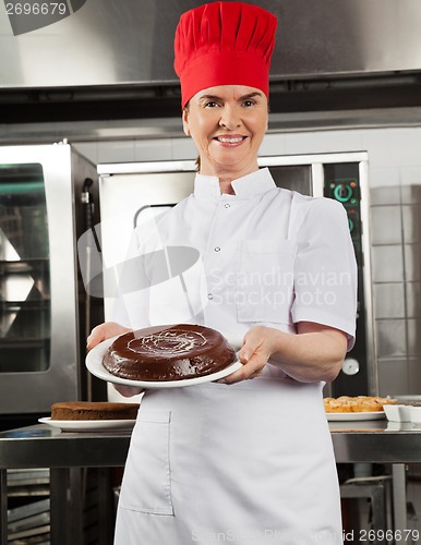 Image of Female Chef Presenting Chocolate Cake