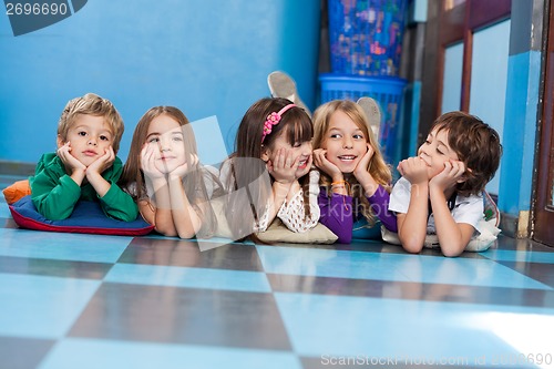 Image of Children Lying In A Row On Floor