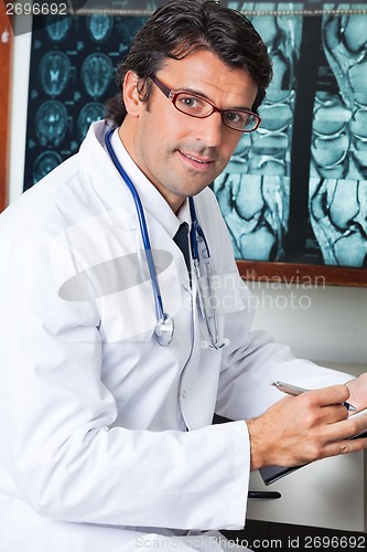 Image of Male Doctor Sitting At Desk