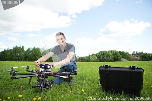 Image of Technician With Octocopter Drone in Park