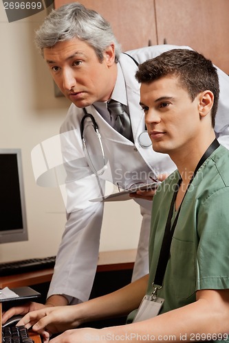 Image of Doctor And Technician Working At Clinic