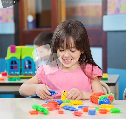 Image of Girl Playing With Colorful Blocks In Classroom