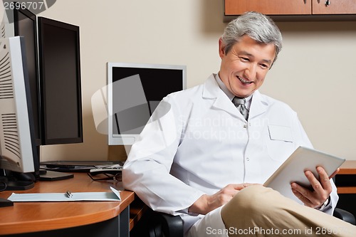 Image of Happy Doctor Holding Digital Tablet