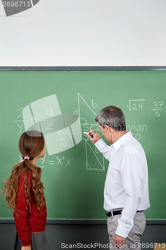 Image of Teacher Teaching Mathematics To Teenage Schoolgirl
