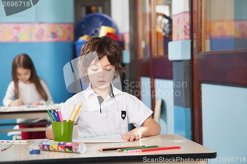 Image of Boy With Color Pencils And Drawing Paper At Kindergarten