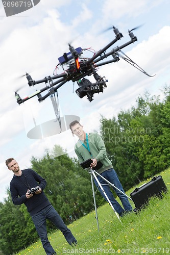 Image of Engineers Flying UAV Drone in Park