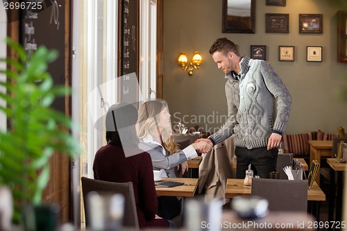 Image of Woman Shaking Hands With Male Friend