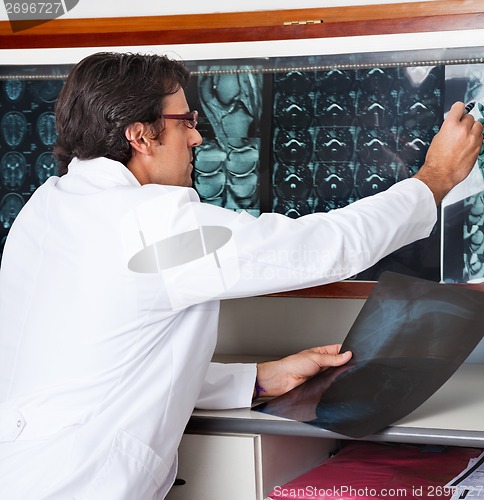 Image of Radiologist Reviewing X-ray At Clinic