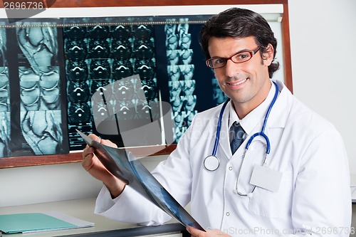 Image of Happy Radiologist Holding X-ray