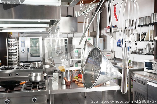 Image of Utensils Hanging In Commercial Kitchen