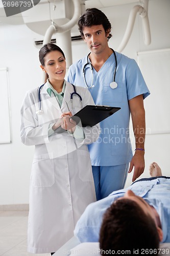Image of Medical Professionals With Patient At Clinic