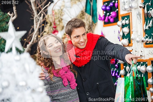 Image of Couple Shopping Christmas Ornaments At Store