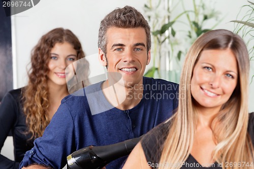 Image of Male And Female Hairstylists At Salon