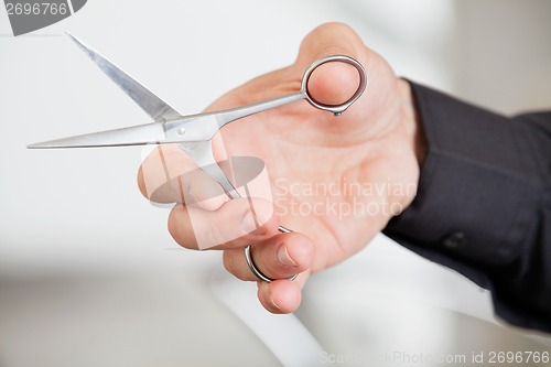 Image of Male Hairdresser's Hand Holding Scissors