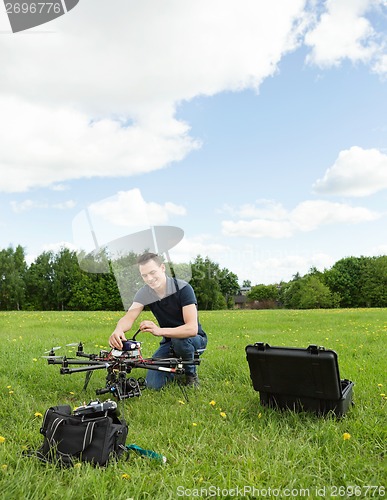 Image of Technician Preparing Multirotor Helicopter