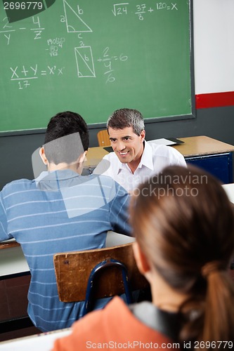 Image of Male Teacher Looking At Student