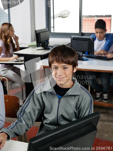 Image of Teenage Male Student Sitting In Computer Class